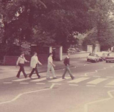 Four Men Crossing The Road on Zebra Crossing